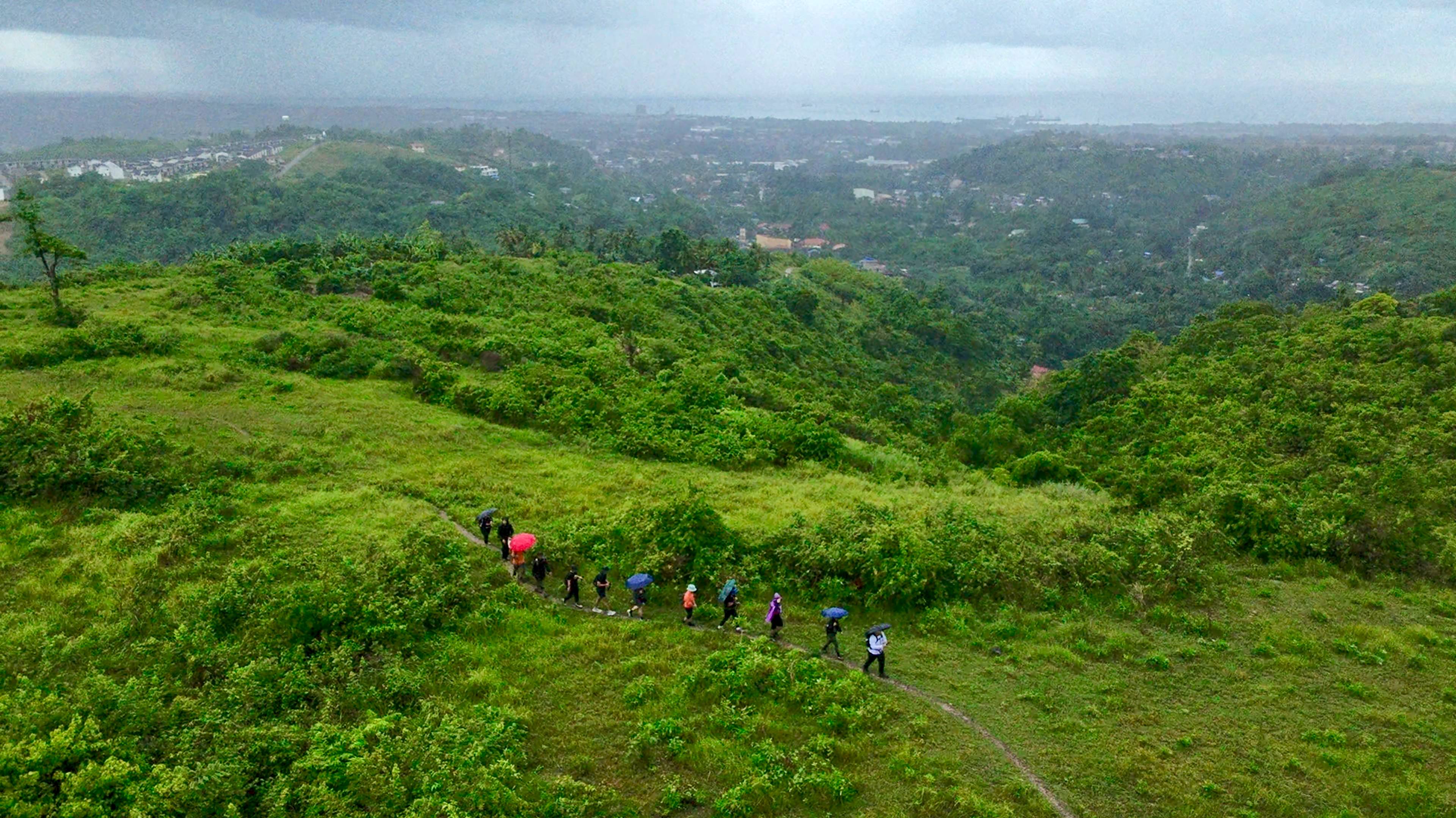 Cebu mountain ridge at sunrise with hikers on trail